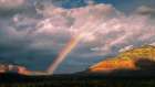 USA, Arizona. Sunrise rainbow over mountain and valley landscape. Art Print